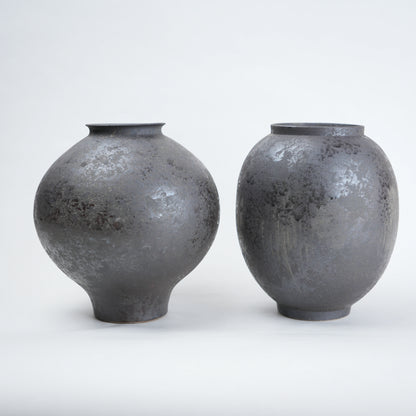 Two gray ceramic vases on a white background