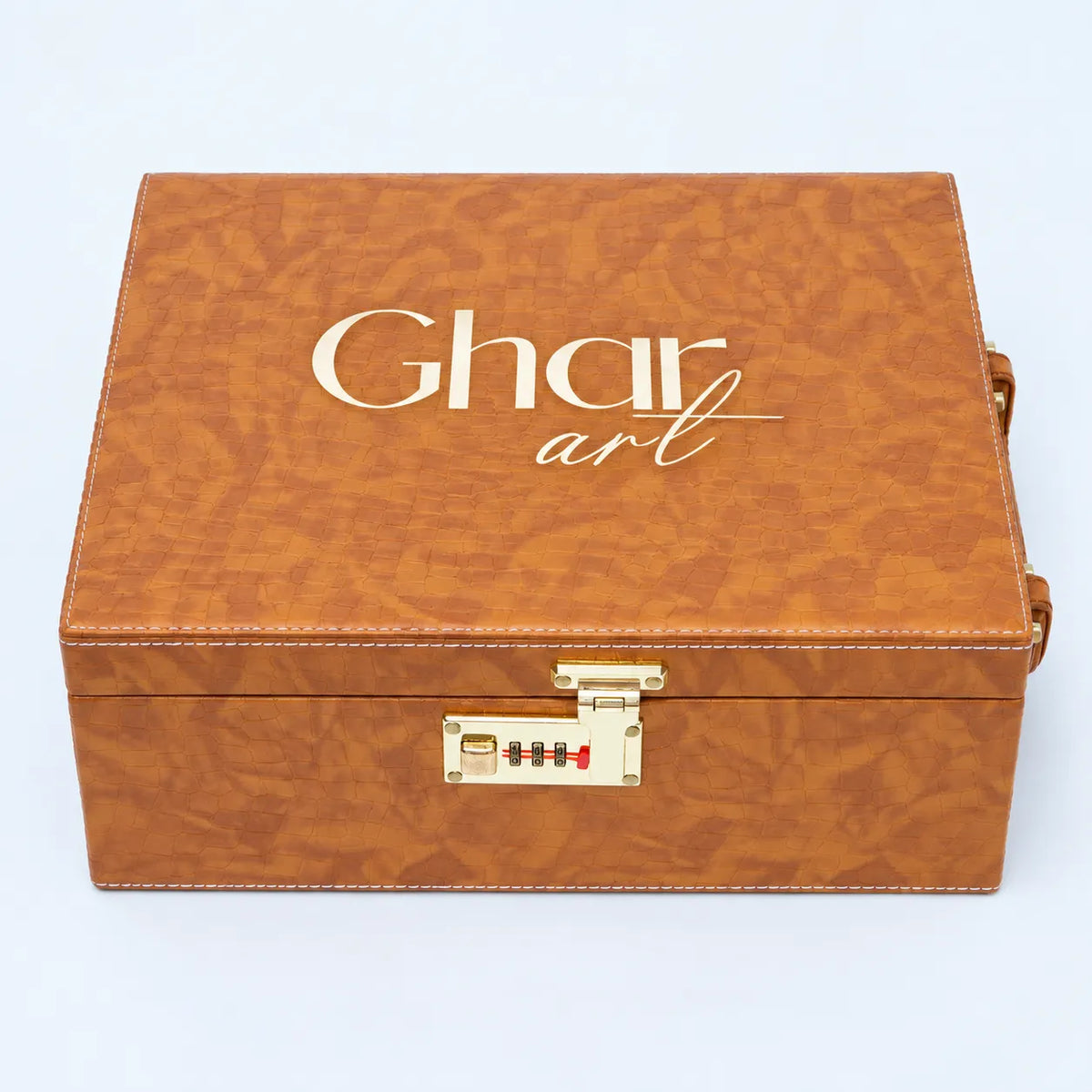 A rectangular brown textured leather-like storage box with a gold-tone combination lock and clasp on the front, featuring the text 'Ghar art' printed in white on the lid, set.