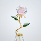 Decorative crystal flower with pink petal and gold stem on a white background