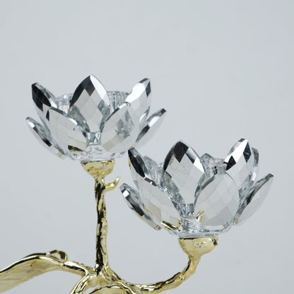 Crystal flower-shaped candle holder with gold base on a light gray background