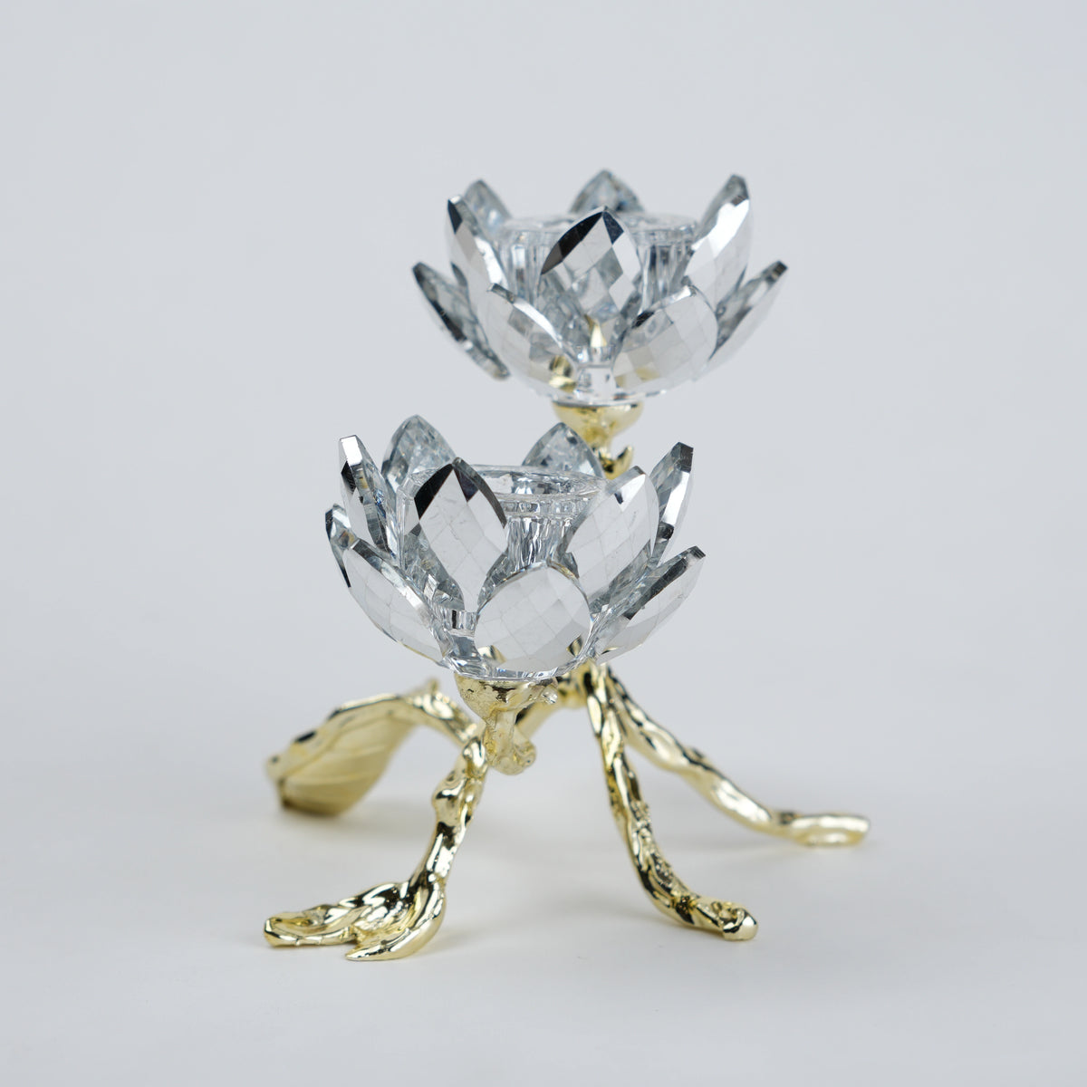 Crystal lotus flower with gold base on a light gray background