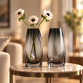 Curved grey vase pair w/ rose, travertine