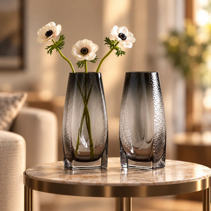 Curved grey vase pair w/ rose, travertine