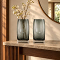 Curved grey vase pair w/ rose, travertine