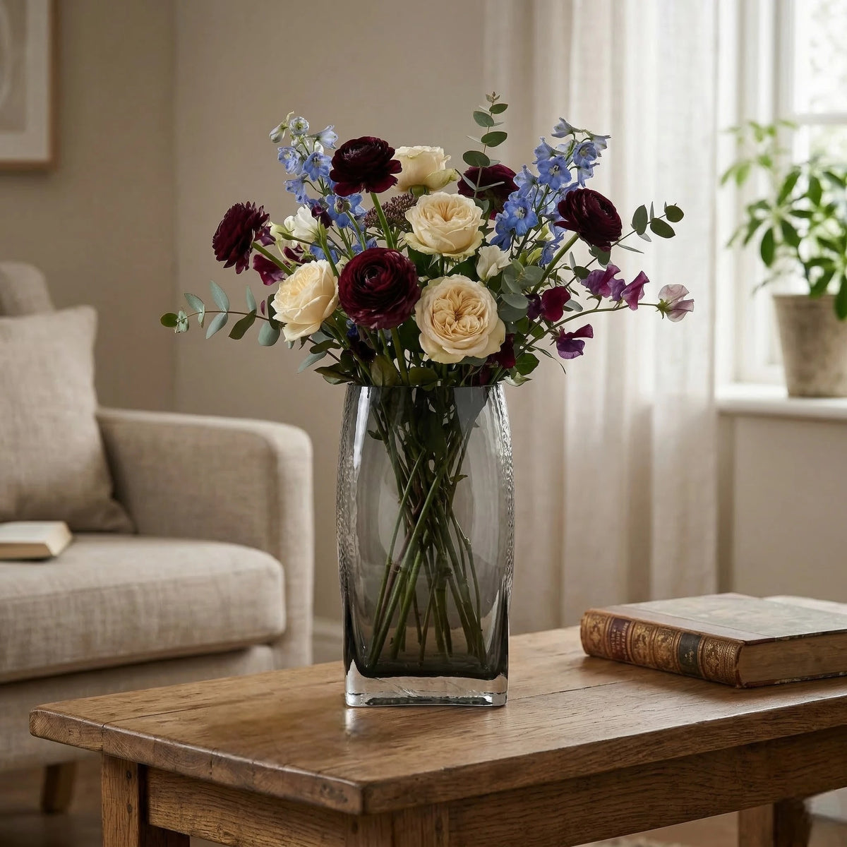 Small curved grey vase w/ ranunculus, oak