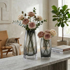 Curved grey vase pair w/ rose, travertine