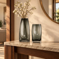 Curved grey vase pair w/ rose, travertine