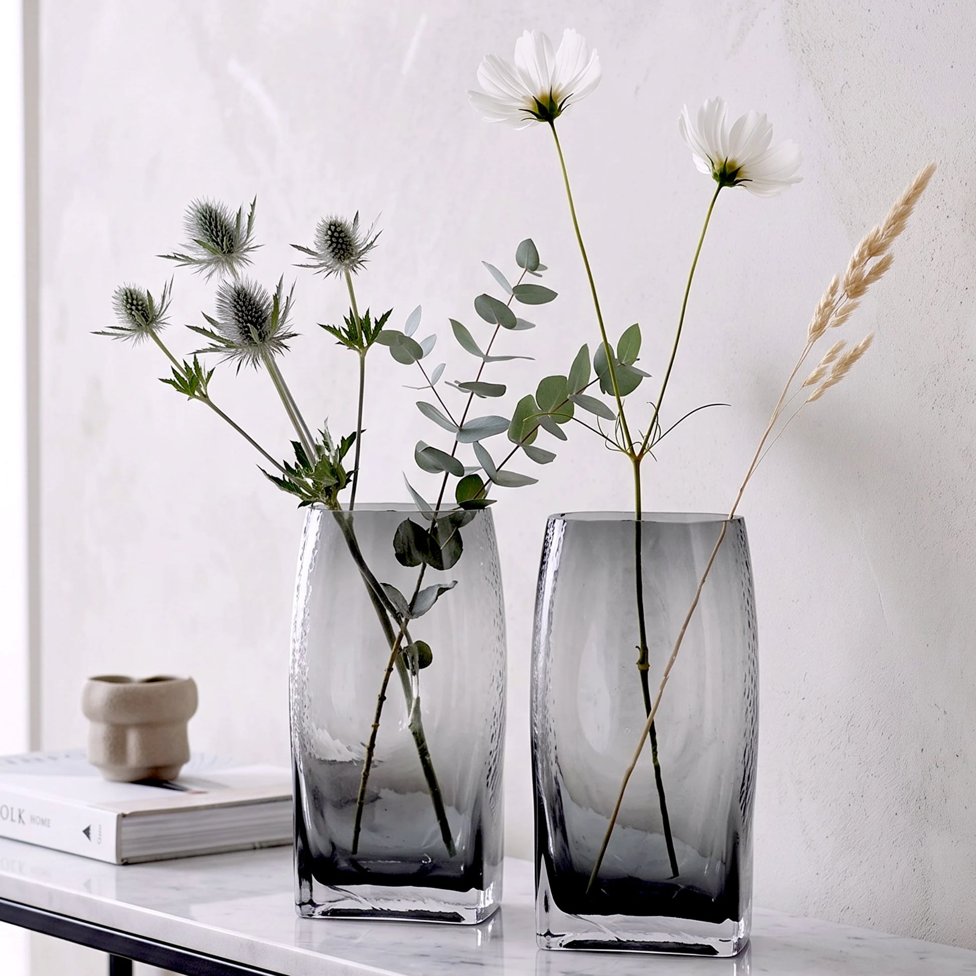 Small curved grey vase w/ ranunculus, oak