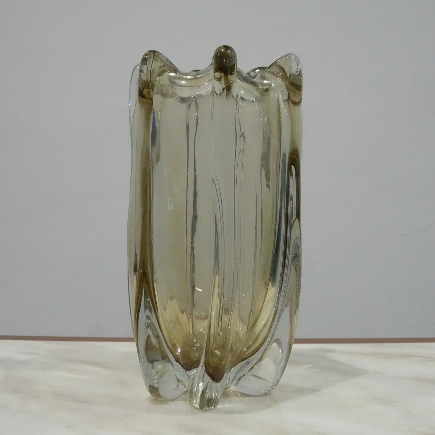 Contemporary art glass vase featuring fluid wave inspired form and handcrafted sculptural detailing for elegant interiors