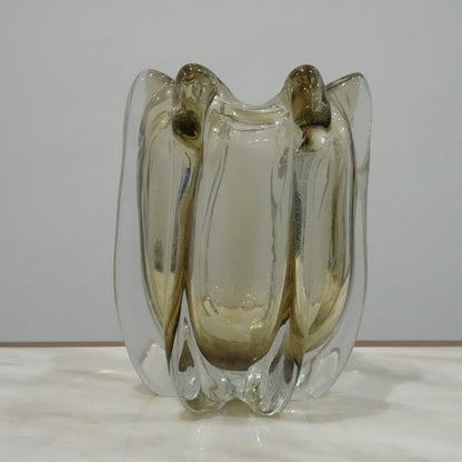 Artisan blown glass vase with soft smoke tint and flowing contemporary silhouette for upscale interior decoration