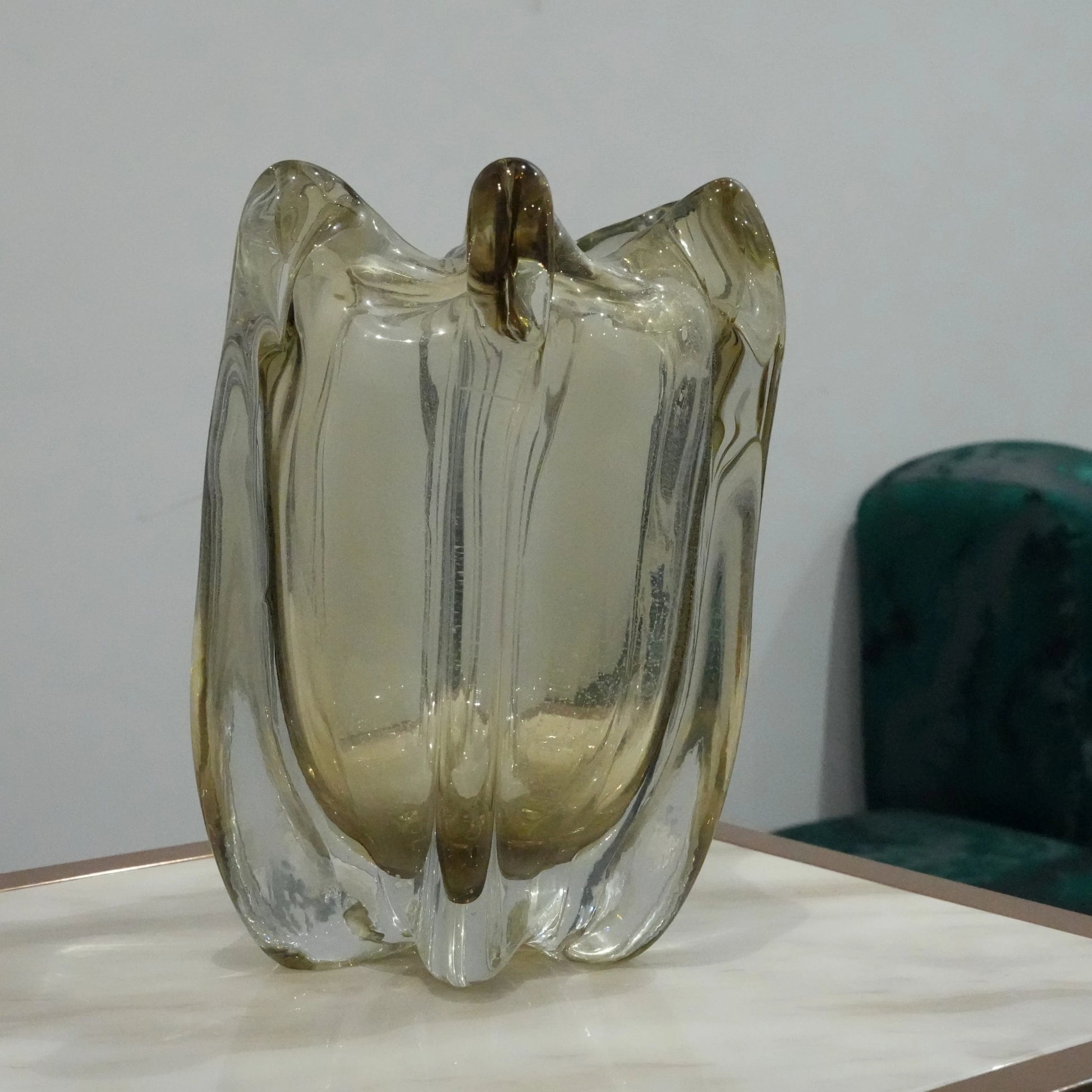 Contemporary decorative vase with organic curved glass structure and translucent smoky finish for premium decor arrangements