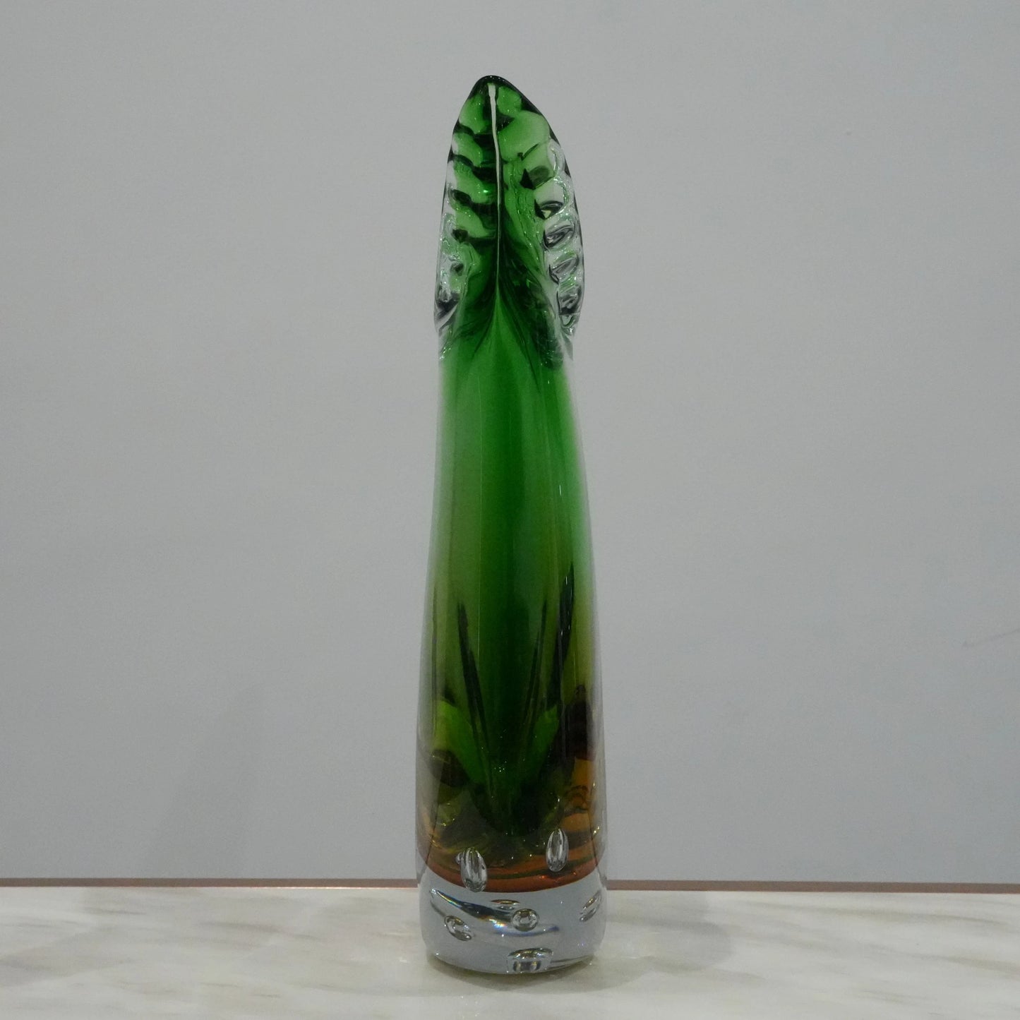 Handblown artistic glass vase with flowing horn silhouette, bubble detailing and green amber gradient finish for luxury modern decor