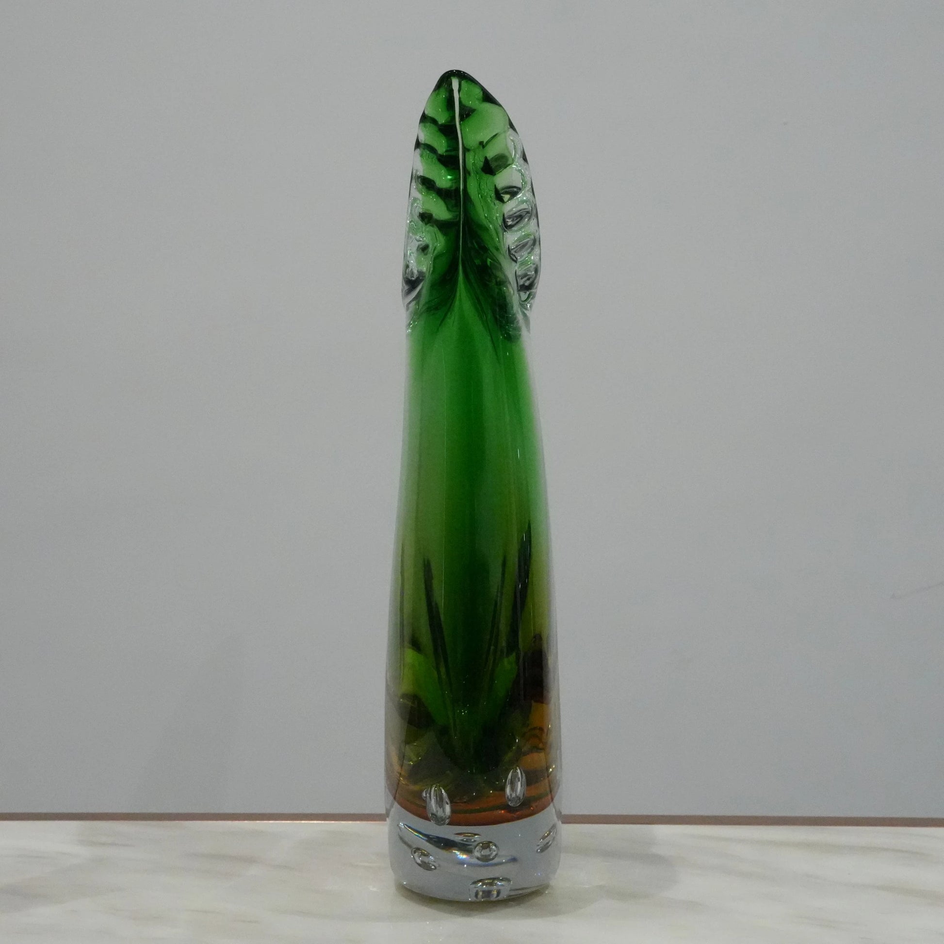 Handblown artistic glass vase with flowing horn silhouette, bubble detailing and green amber gradient finish for luxury modern decor