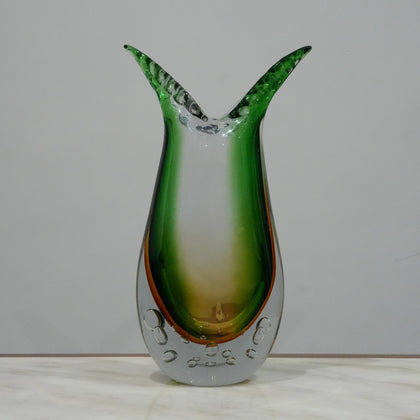 Luxury handblown glass vase featuring sculptural curved form, clear bubble base and contemporary decorative styling for interiors