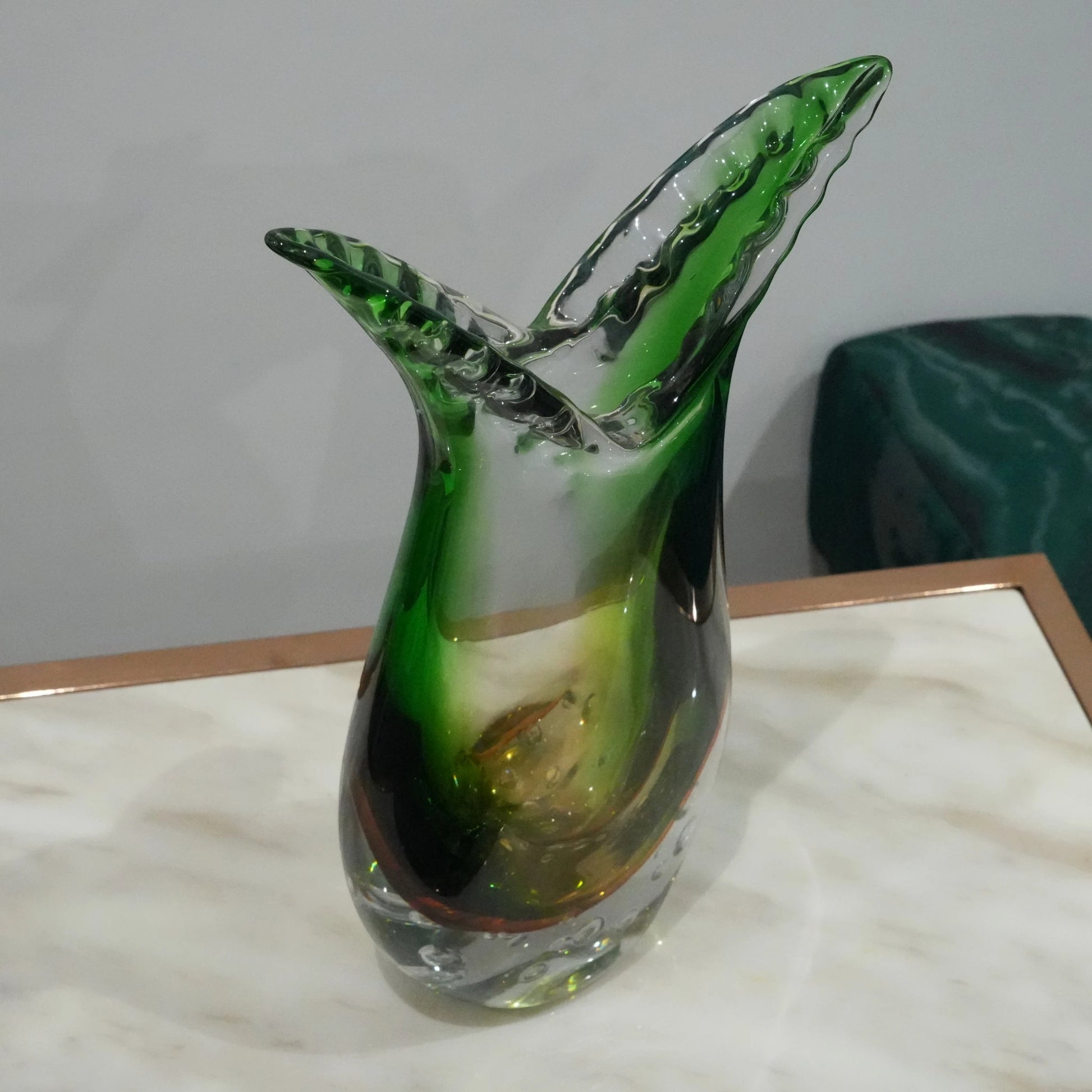 Luxury handblown glass vase featuring sculptural curved form, clear bubble base and contemporary decorative styling for interiors