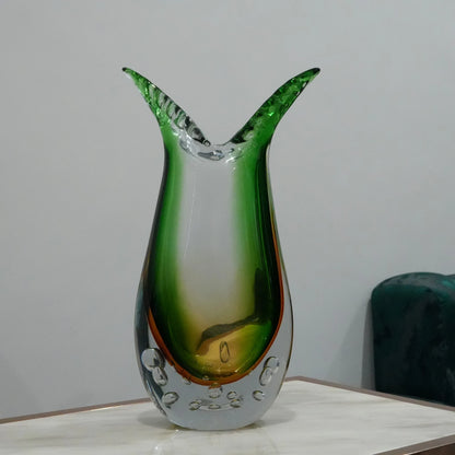 Luxury handblown glass vase featuring sculptural curved form, clear bubble base and contemporary decorative styling for interiors