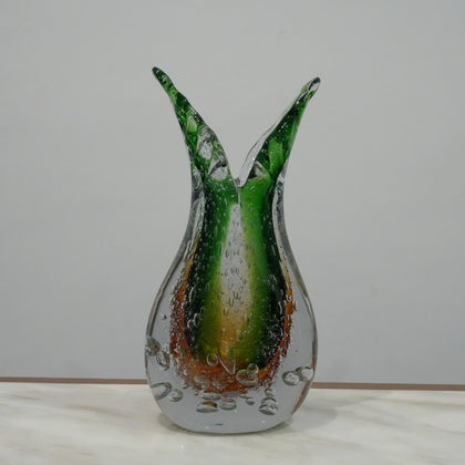 Handblown artistic glass vase with organic twisted silhouette, bubble detailing and green amber gradient finish for luxury decor