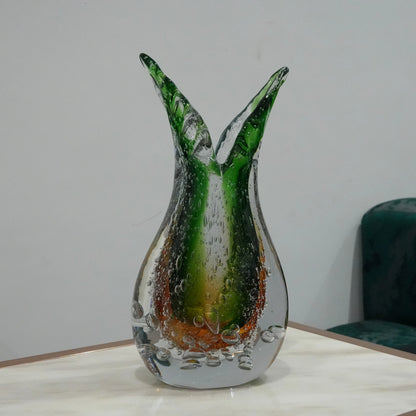 Luxury artisan glass vase with flowing asymmetrical curves and translucent green amber finish for elegant tabletop styling