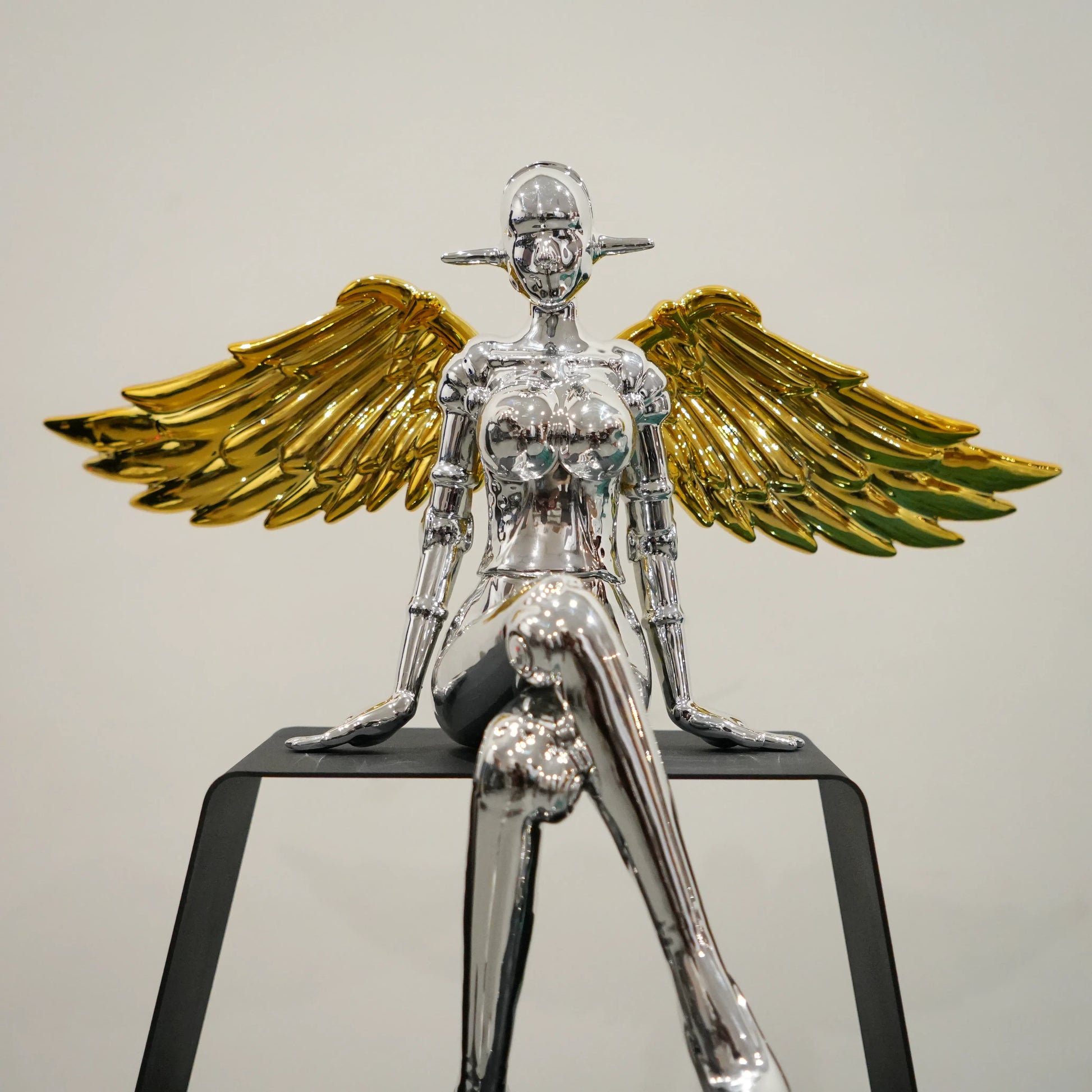 Luxury silver female figurine with gold wings and contemporary design