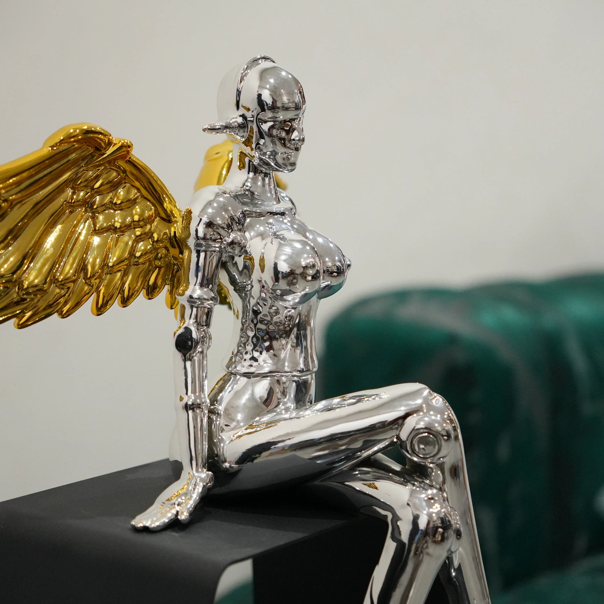 Luxury silver female figurine with gold wings and contemporary design