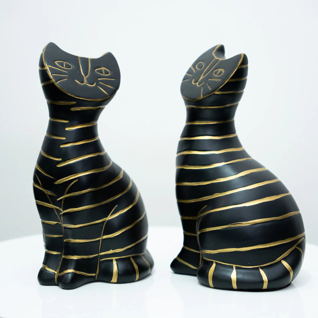 Two black cat figurines with gold stripes, shown from the front and back against a white background.