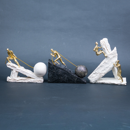 Designer motivational figurine trio with gold human figures and statement bases