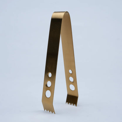 A single metallic gold-colored metal tool, shaped like a bent bracket or tongs with three circular cutouts on each arm and serrated edges at the bottom
