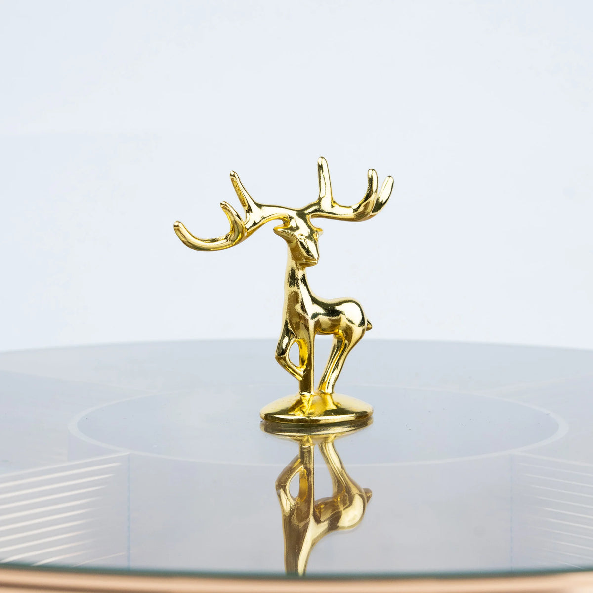 Luxury round glass centrepiece tray featuring golden deer and artistic festive motifs