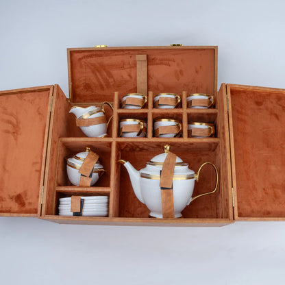 15-piece white ceramic tea set with gold detailing, teapot, cups, saucers and serving pieces