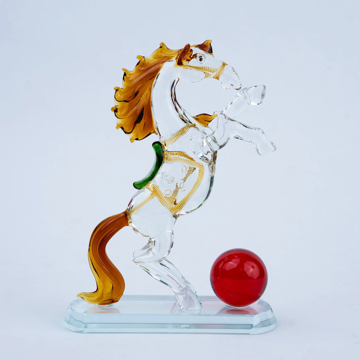Rearing crystal horse figurine with amber tail and red decorative sphere