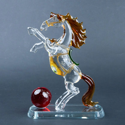 Crystal horse figurine with amber mane, gold details and red sphere on clear base