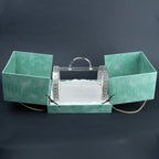Emerald green serving basket presentation case opened to reveal ornate silver metal basket
