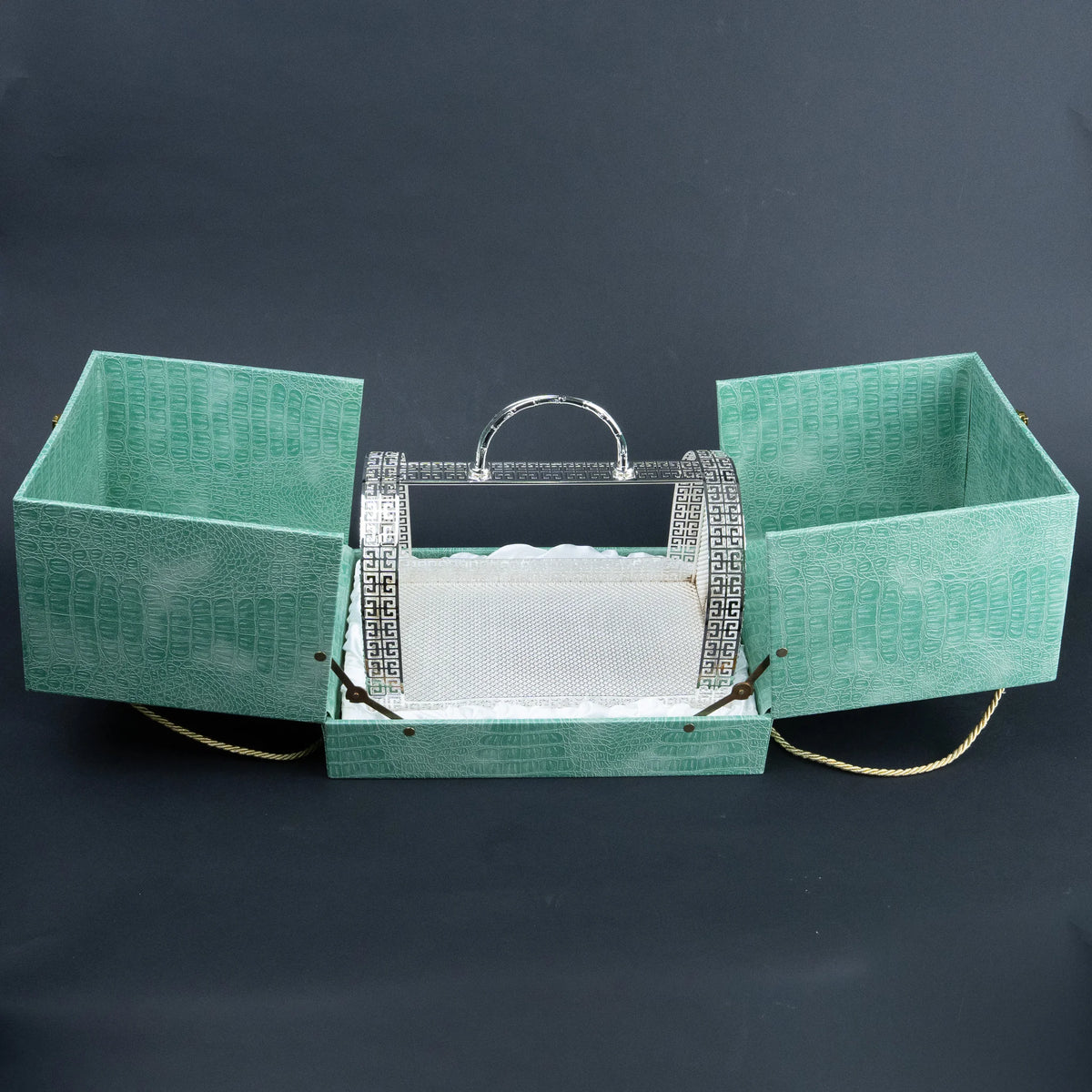 Emerald green serving basket presentation case opened to reveal ornate silver metal basket