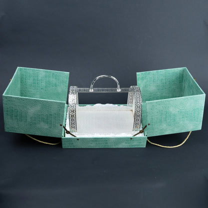 Emerald green serving basket presentation case opened to reveal ornate silver metal basket