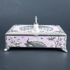 Ornate peacock jewellery box with burgundy lined interior and compartmentalised storage