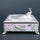 Ornate peacock jewellery box with silver detailing, floral motifs and decorative feet