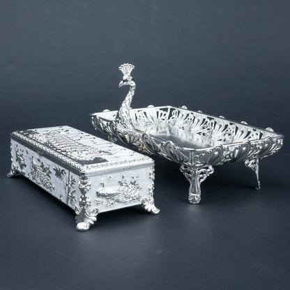 Peacock silver jewellery box with ornate detailing and burgundy velvet interior