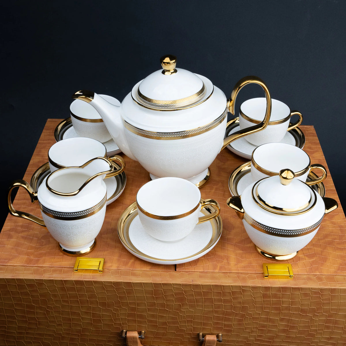 Premium ceramic tea set with gold detailing in a textured cognac brown presentation case
