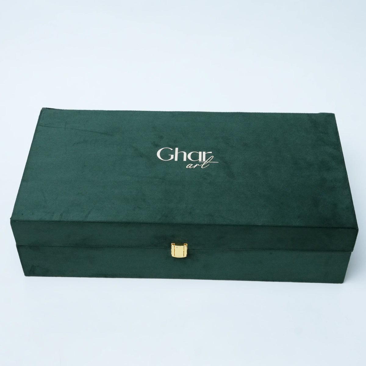 A dark forest green velvet jewelry box with a small gold clasp and the brand name 'Charli art' printed in white on the lid, set against a plain light gray background.