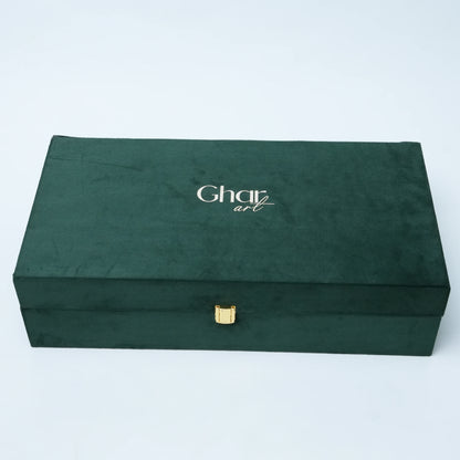A dark forest green velvet jewelry box with a small gold clasp and the brand name 'Charli art' printed in white on the lid, set against a plain light gray background.