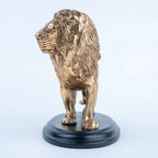 Gold lion figurine with textured mane and black oval base