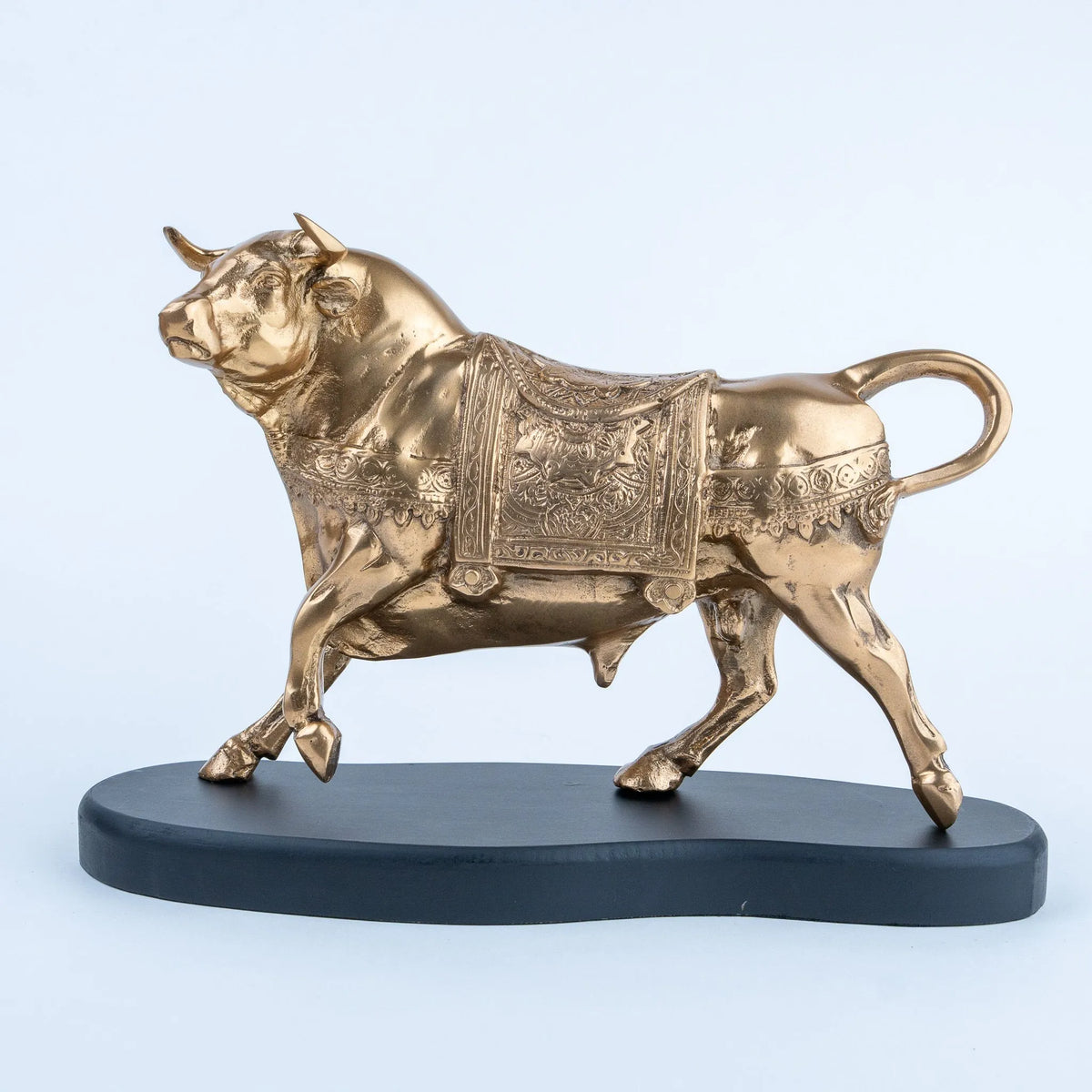 Gold-toned bull showpiece with detailed legs and black display base