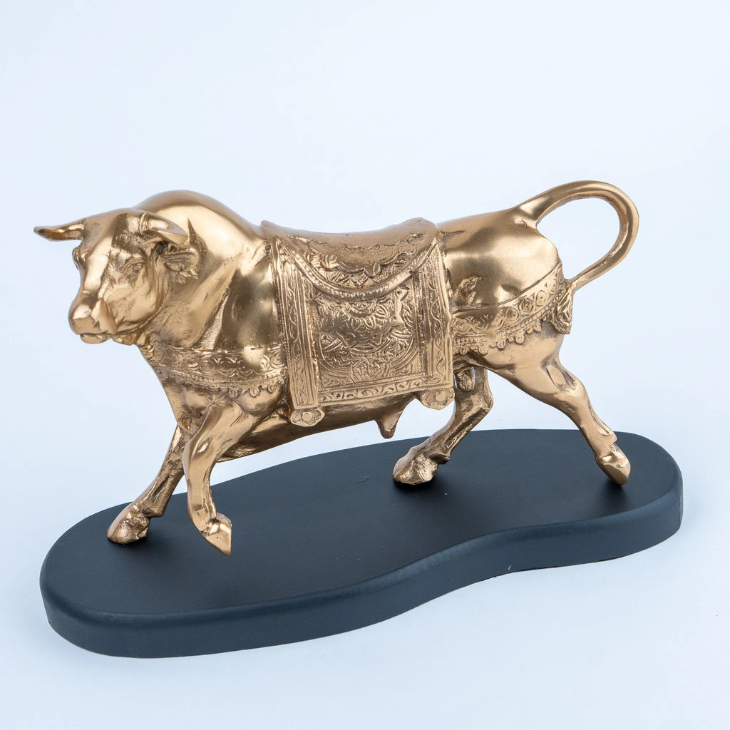 Gold-toned bull showpiece with sculpted horns and ornate detailing
