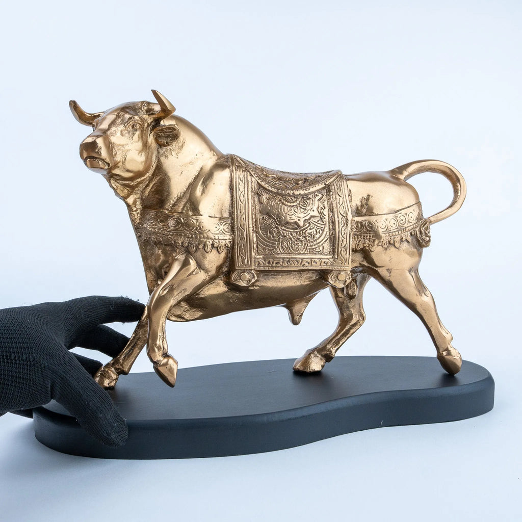 Ornate gold bull statue featuring detailed body patterns and curved horns