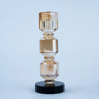 Modern decorative candle holder with stacked geometric forms and black bases