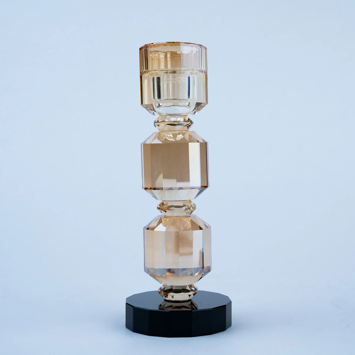 Modern decorative candle holder with stacked geometric forms and black bases