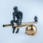 Contemporary decorative sculpture featuring a spherical gold base and linear beam.