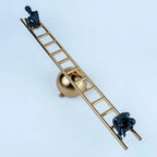 Overhead view of a gold geometric sculpture with two black seated figures