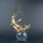 Gold koi fish decorative sculpture with blue crystal-like accents and clear spherical base.