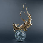 Luxury gold fish showpiece featuring detailed scales, blue embellishments and clear base.